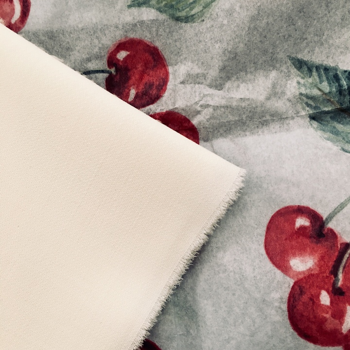 Material sample of cherry patterned tissue paper.